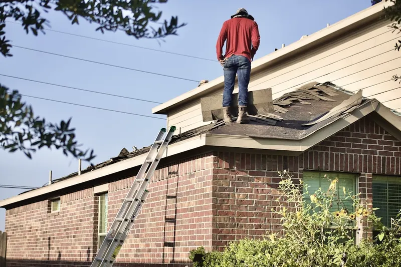 Professional roofer working on a residential roof in Yankee Springs